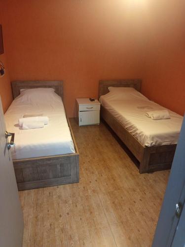 two twin beds in a room with at Kavela555 in Tbilisi City
