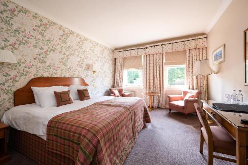 a hotel room with a bed and a desk at The Open Arms Hotel in Dirleton