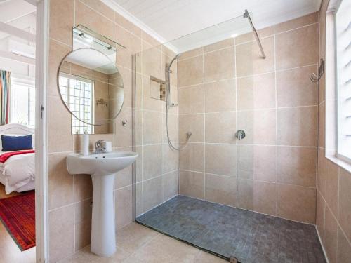 a bathroom with a shower and a sink at Cosimi Guest House in Durbanville