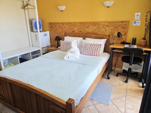 a bedroom with a bed with a cat sitting on it at Dream Lagos B&B in Lagos