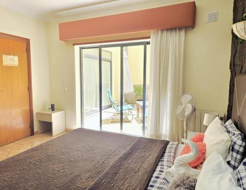 a bedroom with a bed with a view of a patio at Dream Lagos B&B in Lagos