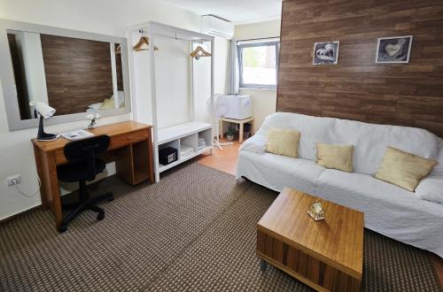 a living room with a couch and a desk at Dream Lagos B&B in Lagos