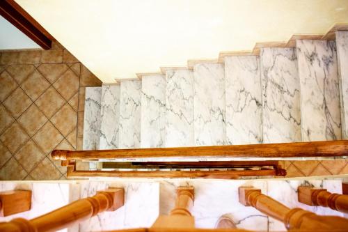 a bathroom with a marble wall and pipes at Dream Lagos B&B in Lagos