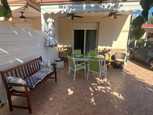 a patio with a table and chairs on a patio at Kaly Mare Sithonia in Kalyves Poligirou