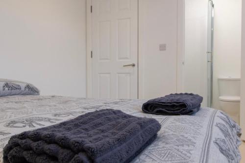 a bedroom with a bed with two pillows on it at Radstock Road - Room 3a in Southampton