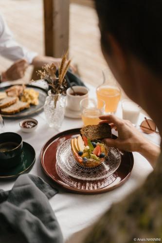 a table topped with a plate of food with a bowl of food at Les Chambres du parc in Monnières
