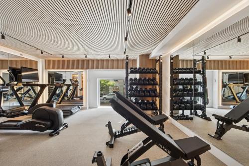 a gym with treadmills and elliptical machines at Hotel Park Ave NYC in New York