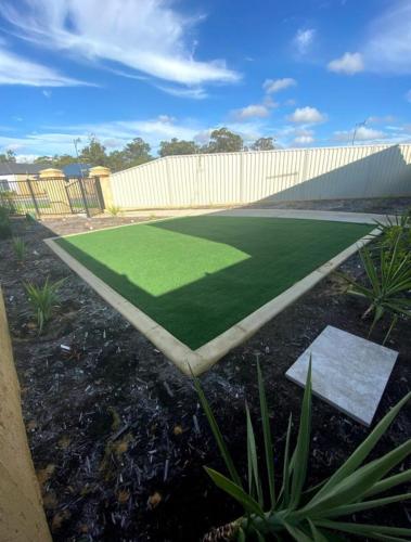 a large artificial grass field in front of a building at Baldivis Home Close to IGA, CAFE, Restaurants, 15 mins to beach in Baldivis