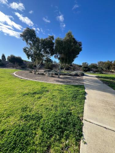 a path in a park with trees and grass at Baldivis Home Close to IGA, CAFE, Restaurants, 15 mins to beach in Baldivis
