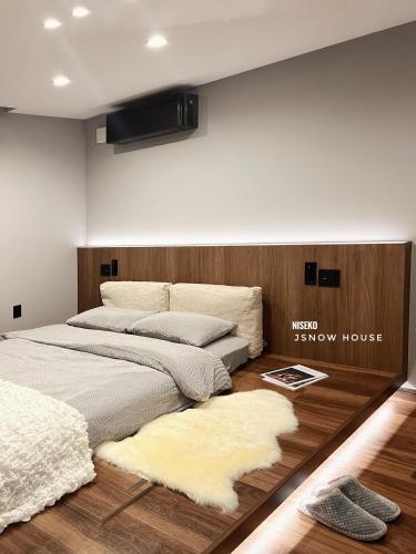 a bedroom with two beds and a tv on the wall at JY Snow in Kutchan