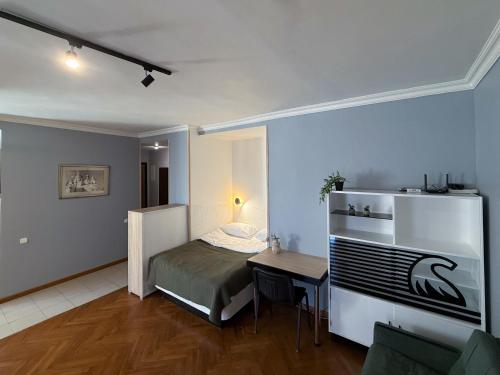a small room with a bed and a table in it at Kyiv History Apartment in Kyiv