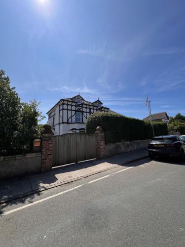 a house with a car parked on the side of a street at Beach View Apartment in West Kirby