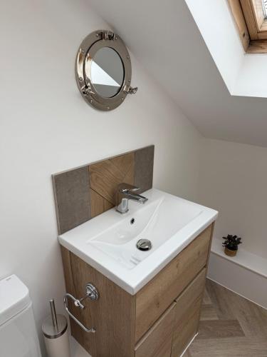 a bathroom with a sink and a mirror on the wall at Beach View Apartment in West Kirby