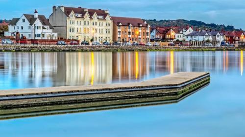 a view of a river with houses and buildings at Beach View Apartment in West Kirby