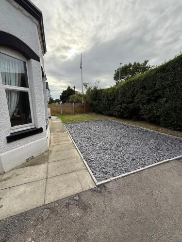 a driveway of a house with a window at Beach View Apartment in West Kirby