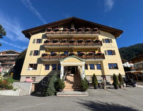 a large building with balconies on top of it at Piccolohotel Tempele Residence in San Candido