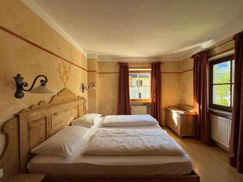 a bedroom with two beds and a window at Piccolohotel Tempele Residence in San Candido