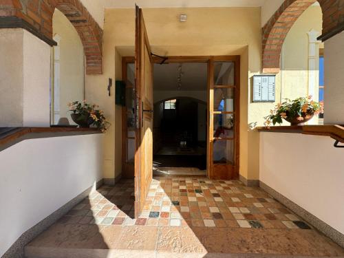 a hallway of a house with a door and a tile floor at Piccolohotel Tempele Residence in San Candido