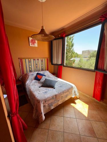 a bedroom with a bed and a large window at Bel appartement à Oualidia in Oualidia