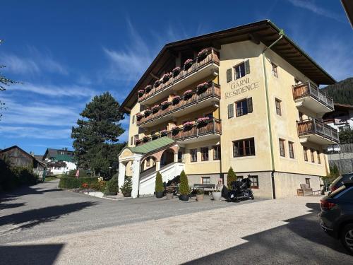 a large building with balconies on the side of it at Piccolohotel Tempele Residence in San Candido