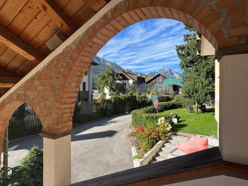 an archway in a house with a garden at Piccolohotel Tempele Residence in San Candido