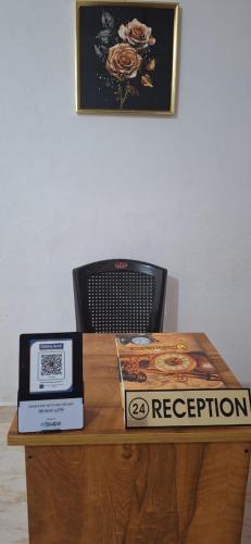 a wooden table with a box on top of it at Holiday Apartments & Homestay in Sultan Bathery