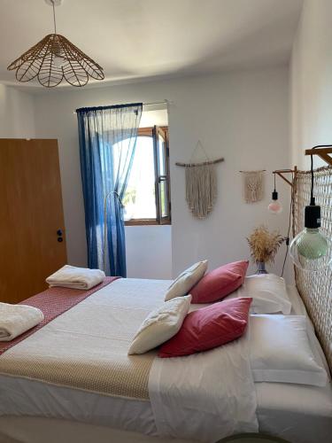 a bedroom with two beds with pillows on them at Monte do Luar in São Brás de Alportel