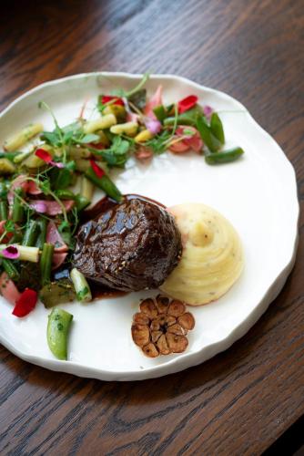 a plate of food on a wooden table at Hotel Ilan in Lublin