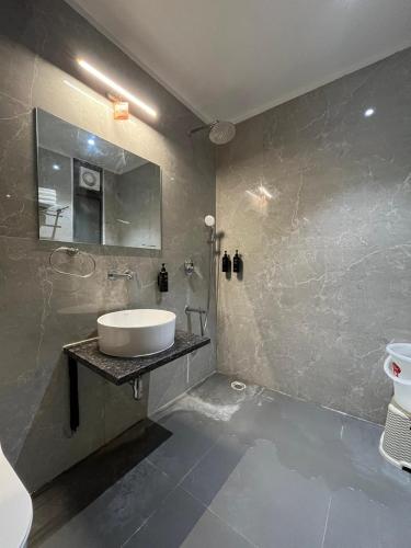 a bathroom with a sink and a mirror at Hotel Krishna Anandam in Vrindāvan