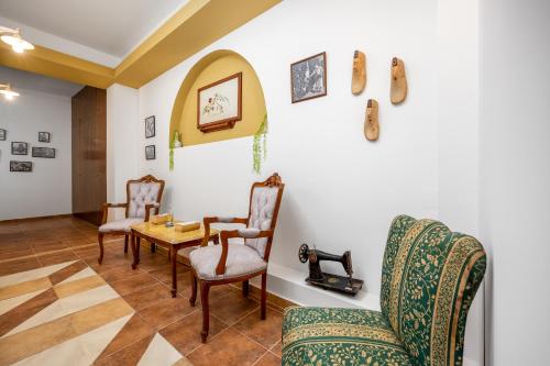 a living room with chairs and a table at The Old Symi in Symi