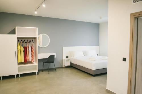 a bedroom with a bed and a desk and a chair at Olimpia Villas I Luxury villas with private pools! in Epáno Kefalás