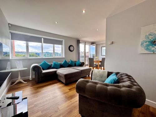 a living room with a couch and a chair at Swan Apartments 2A Cosy City Break Staycation in Newcastle upon Tyne