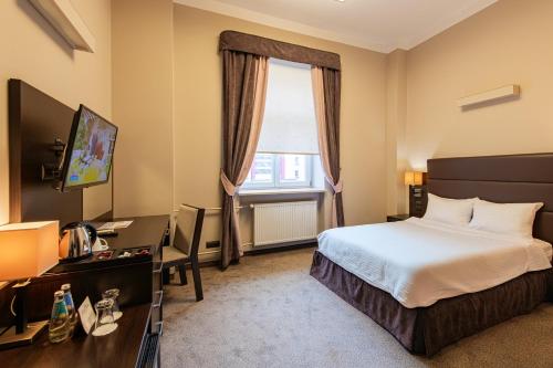 a hotel room with a bed and a window at Hotel Ilan in Lublin