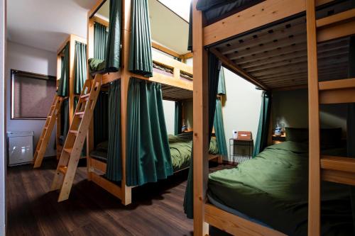 a room with three bunk beds and a ladder at MusicInn Matoya - Vacation STAY 88768v in Sumoto