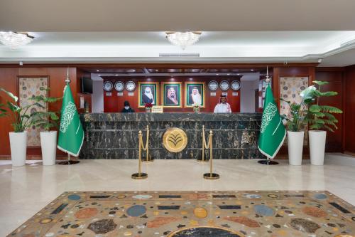 a lobby of a consulate with flags on the floor at Al Shohada by Palm Rich Makkah in Makkah