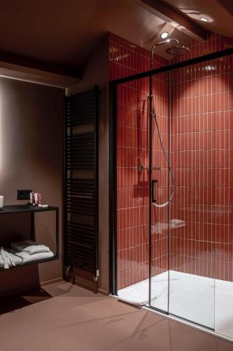 a shower with a glass door in a bathroom at Hostellerie Kemmelberg in Kemmel