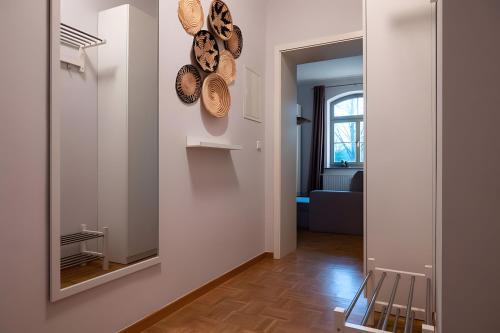 a hallway with a mirror and plates on the wall at Ferienwohnung Lindner 2 in Weimar