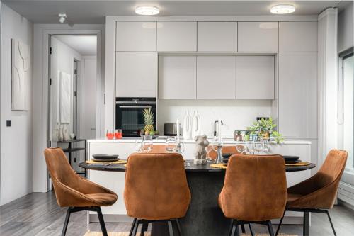 a kitchen with a table and chairs in a room at Unbeatable Central Location - Reykjavíks Most Exclusive Luxury Apartments in Reykjavík
