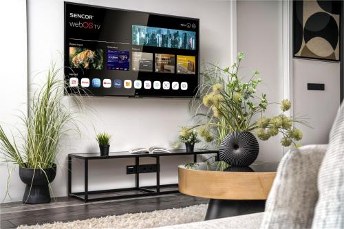 a living room with a coffee table and a tv at Unbeatable Central Location - Reykjavíks Most Exclusive Luxury Apartments in Reykjavík