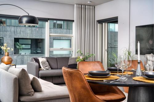a living room with a table and a couch at Unbeatable Central Location - Reykjavíks Most Exclusive Luxury Apartments in Reykjavík