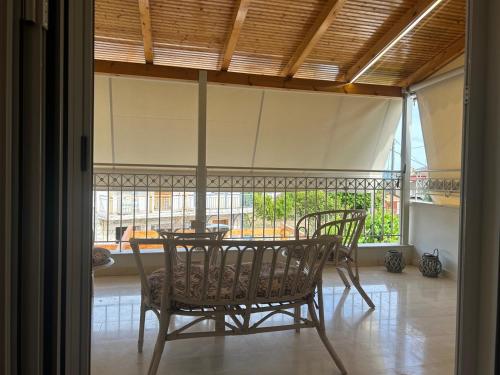 a dining room with a table and chairs in a room at THEODORA SUITE SMART KEY BOX by PROJECT 86 IKE in Agrinion