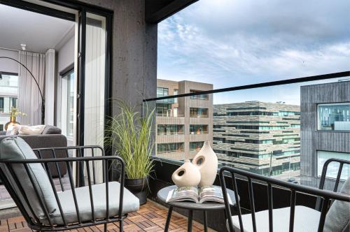 a balcony with chairs and a vase on a table at Unbeatable Central Location - Reykjavíks Most Exclusive Luxury Apartments in Reykjavík