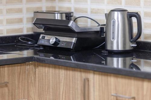 a coffee maker on a counter in a kitchen at Luxury Villa sea view and free paddle boat - Al Dana Island Fujairah in Fujairah