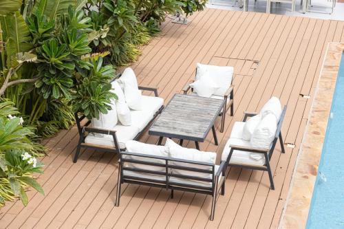 a patio with a table and chairs next to a pool at Luxury Villa sea view and free paddle boat - Al Dana Island Fujairah in Fujairah