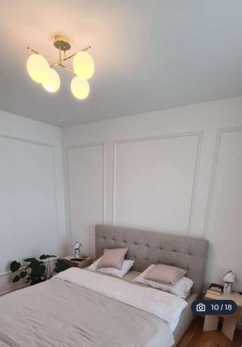 a bedroom with a bed and a ceiling fan at Ostoya in Rumia