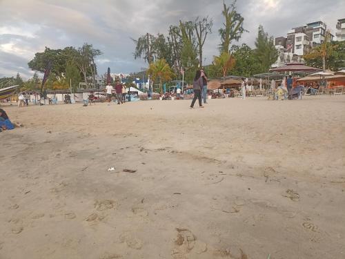 a person flying a kite on the beach at Sri sayang pearl view in Batu Ferringhi