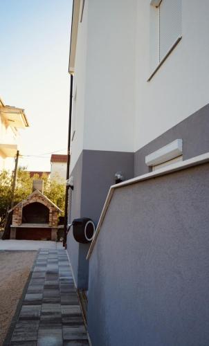 a hallway of a building with a stairway at Apartmani Dusper in Vodice