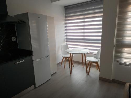 a kitchen with a table and chairs and a window at Valle del Sol in Ceuti