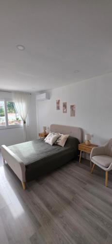 a bedroom with a large bed and a chair at Algarve Dream Escape in Armação de Pêra