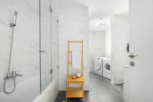 a bathroom with a washing machine and a washer and dryer at O&O Group - 3BR Skyline Retreat on the 24th Floor in Bat Yam